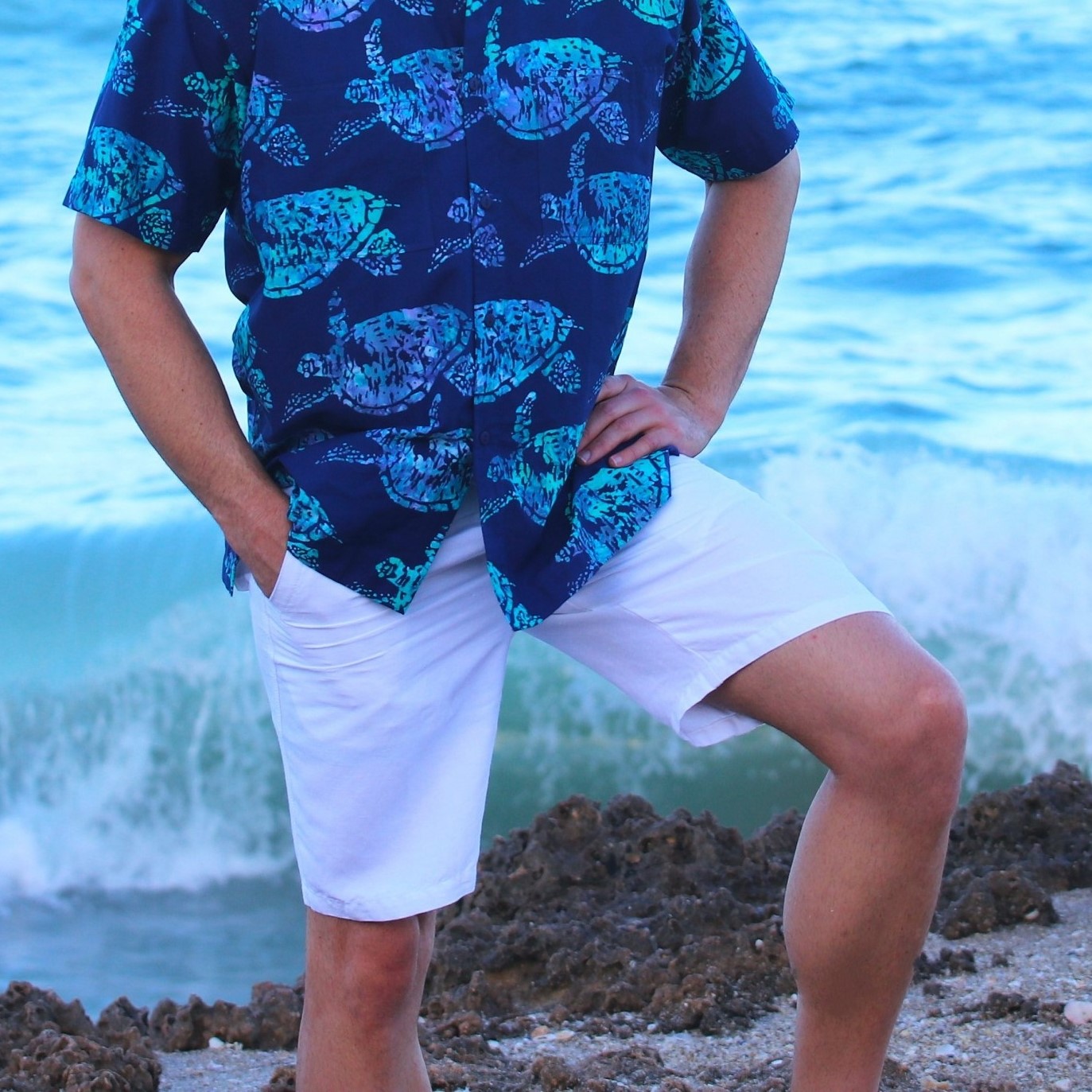 Model-on-Rocky-Beach-wearing-Hawaiian-Shirt-Shirtle-Turtle-and-St-Barts-Shorts-in-white