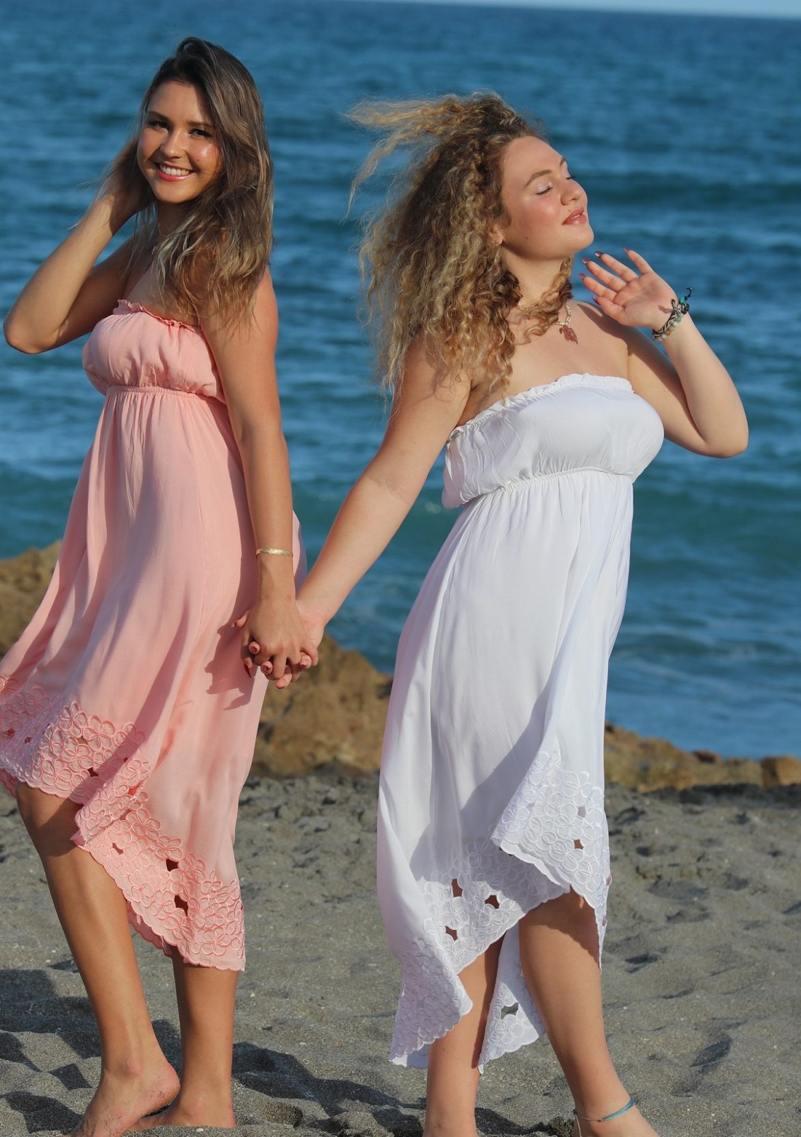 Strapless-Sundress-Angels-by-the-Sea-Waikiki-Moon-Coral-or-White-models-holding-hands-at-the-beach