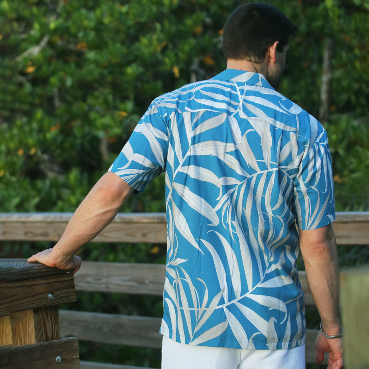 Paradise Found Hawaiian Shirt – Palm Fronds – Blue –  Model on Pier – Back view