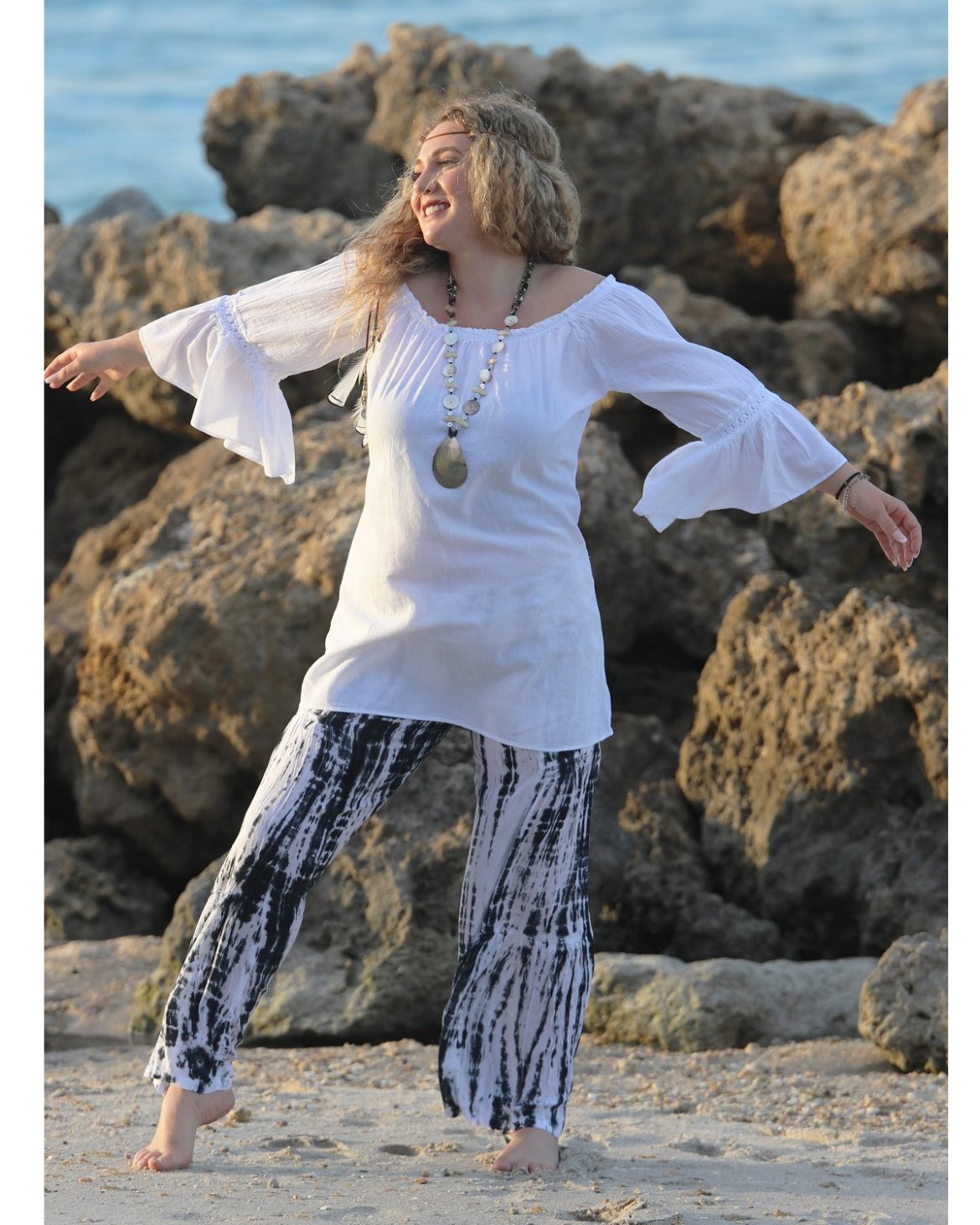 Boho-Chic-Blouse-Harmony-White-front-view-model-on-beach-outstretched arms