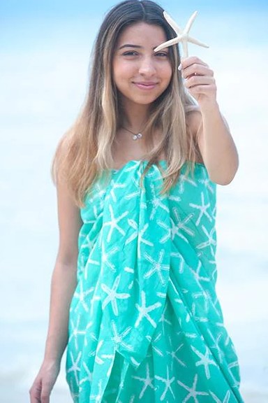Sarong-bathing-suit-coverup-100-cotton-Wishes-starfish-Splash-Mint-Green-model-on-beach-holding-real-starfish-smiling